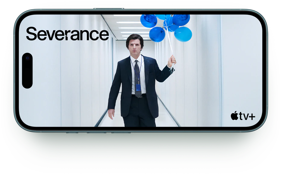 iPhone 16 Plus med serien "Severance" på skærmen, tekst om bedre batteri med op til 27 timers videoafspilning på Plus og 22 timer på iPhone 16.